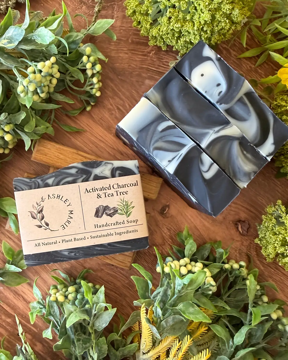 Activated Charcoal & Tea Tree Soap photographed on wood with dried flowers