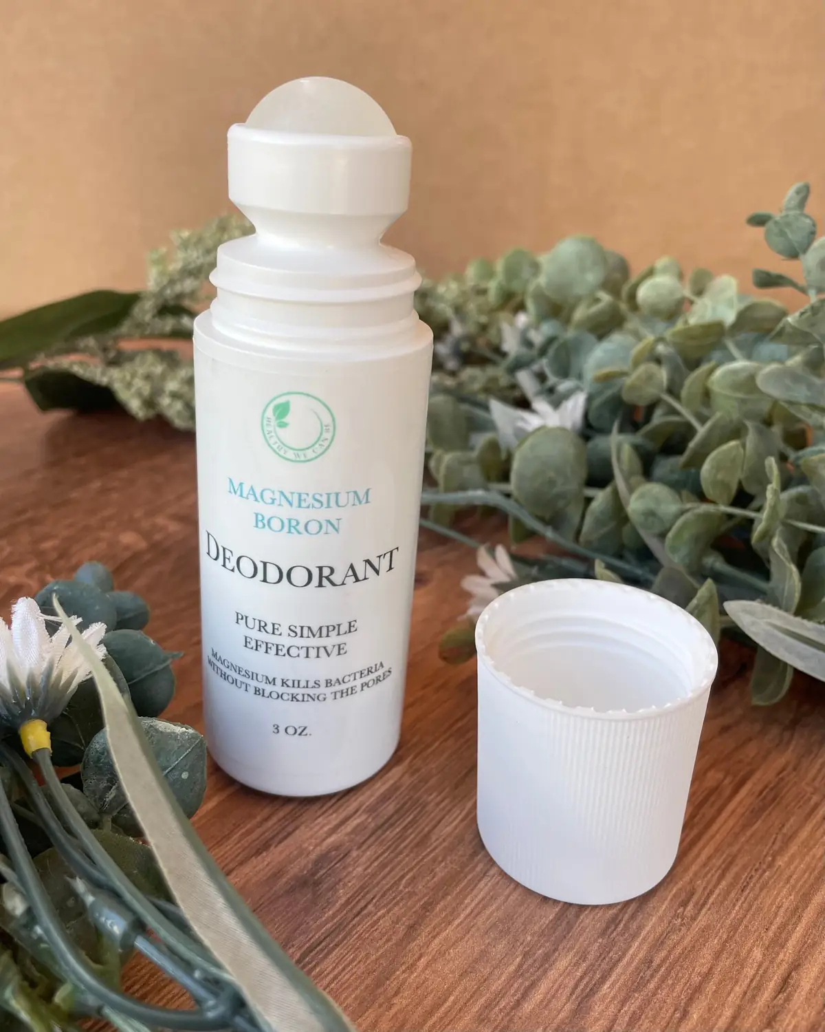 Deodorant photographed on wood with dried flowers
