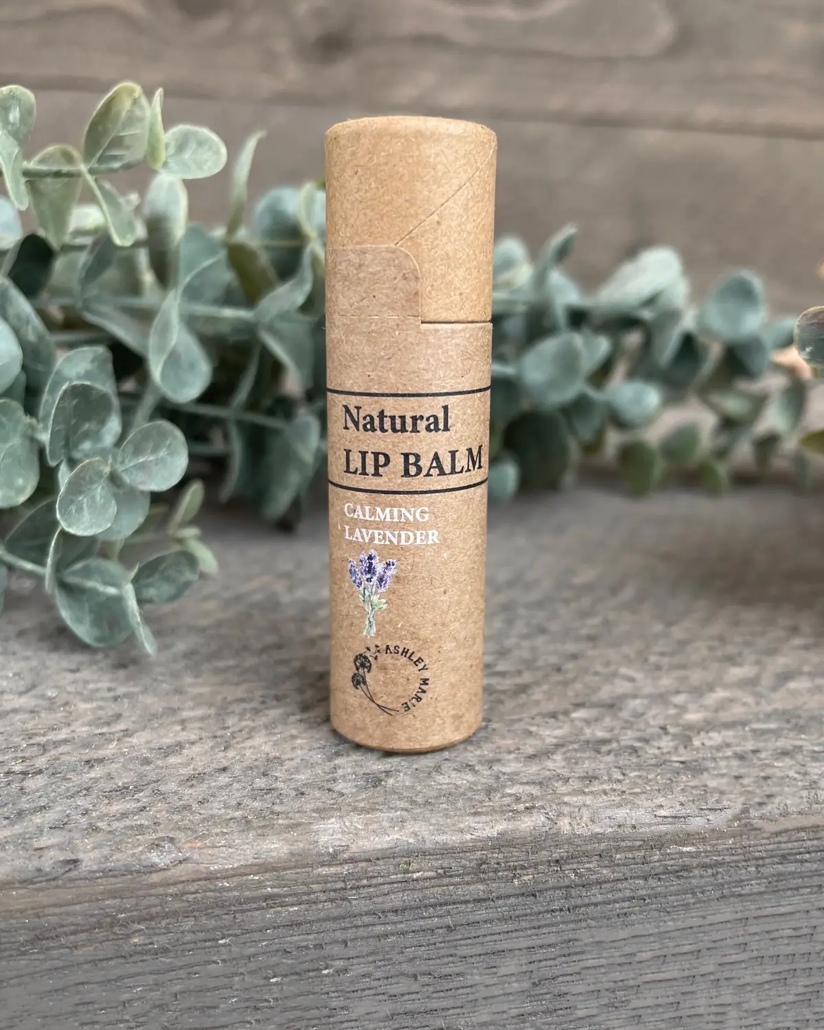 Lip Balm photographed on wood with dried flowers
