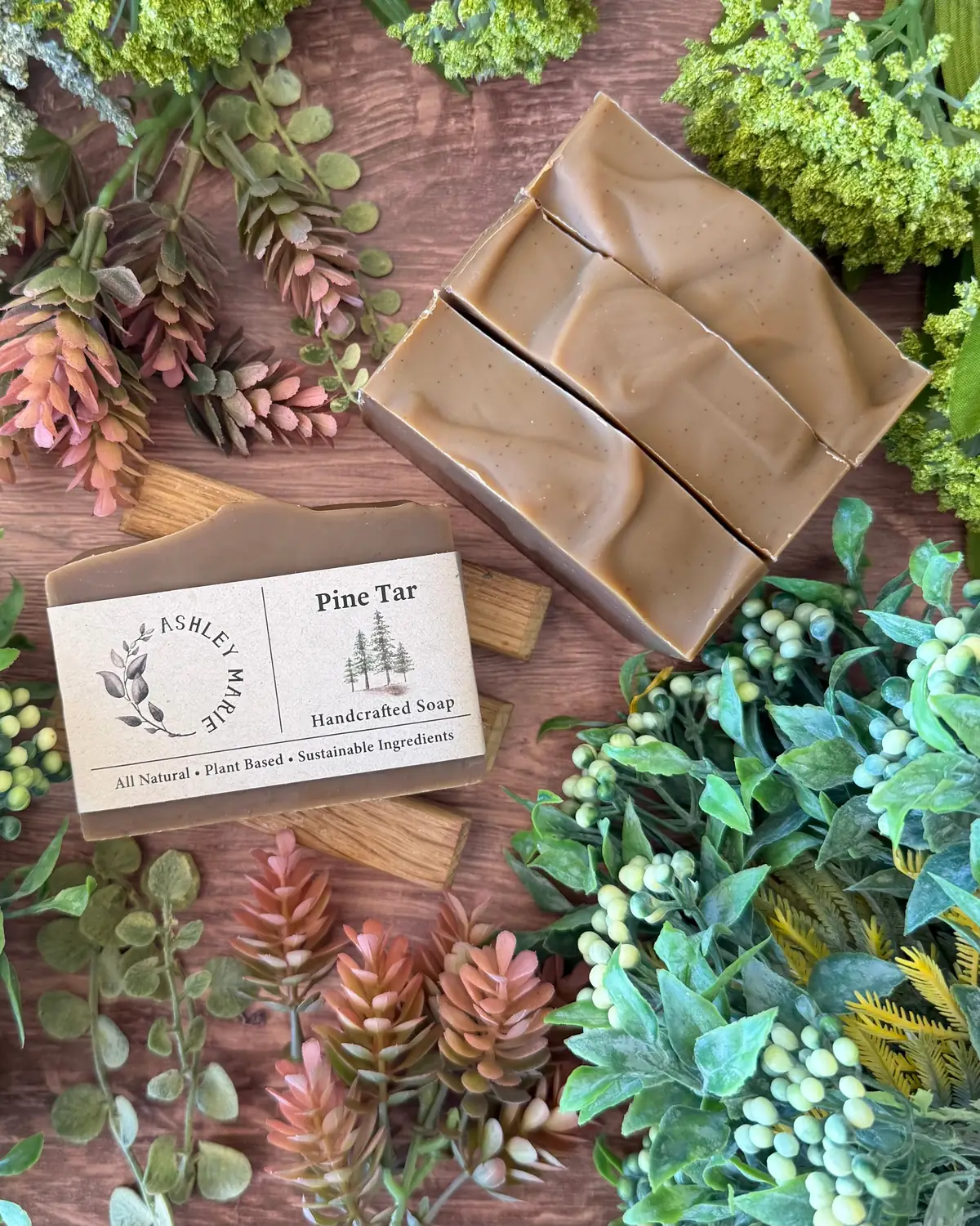 Pine Tar Soap photographed on wood with dried flowers