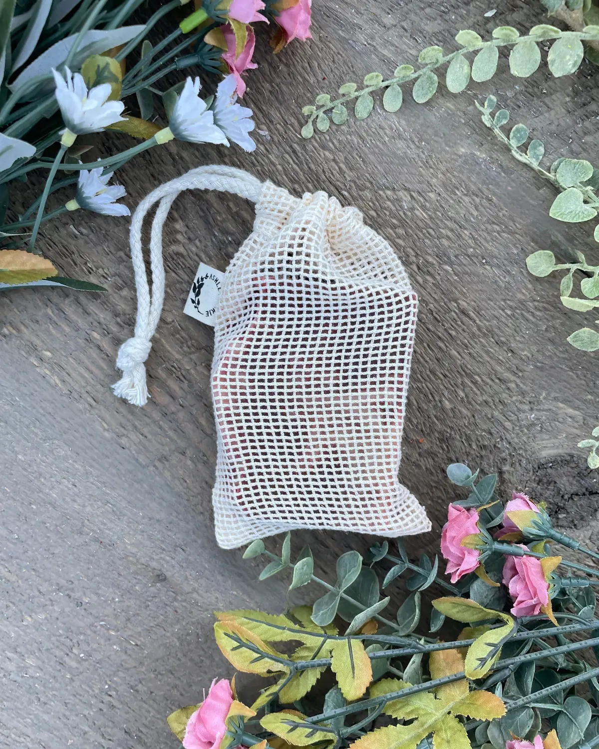 Soap Saver Pouch photographed on wood with dried flowers