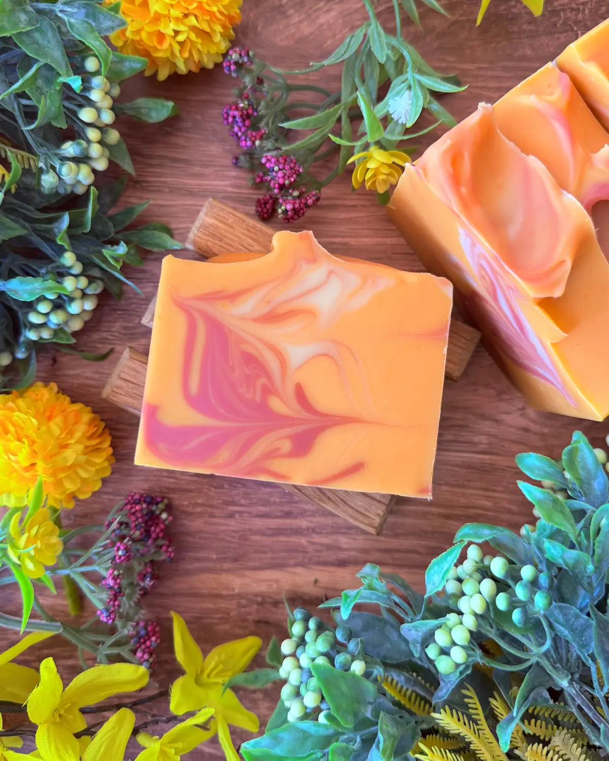 Sweet Orange Hibiscus Soap photographed on wood with dried flowers