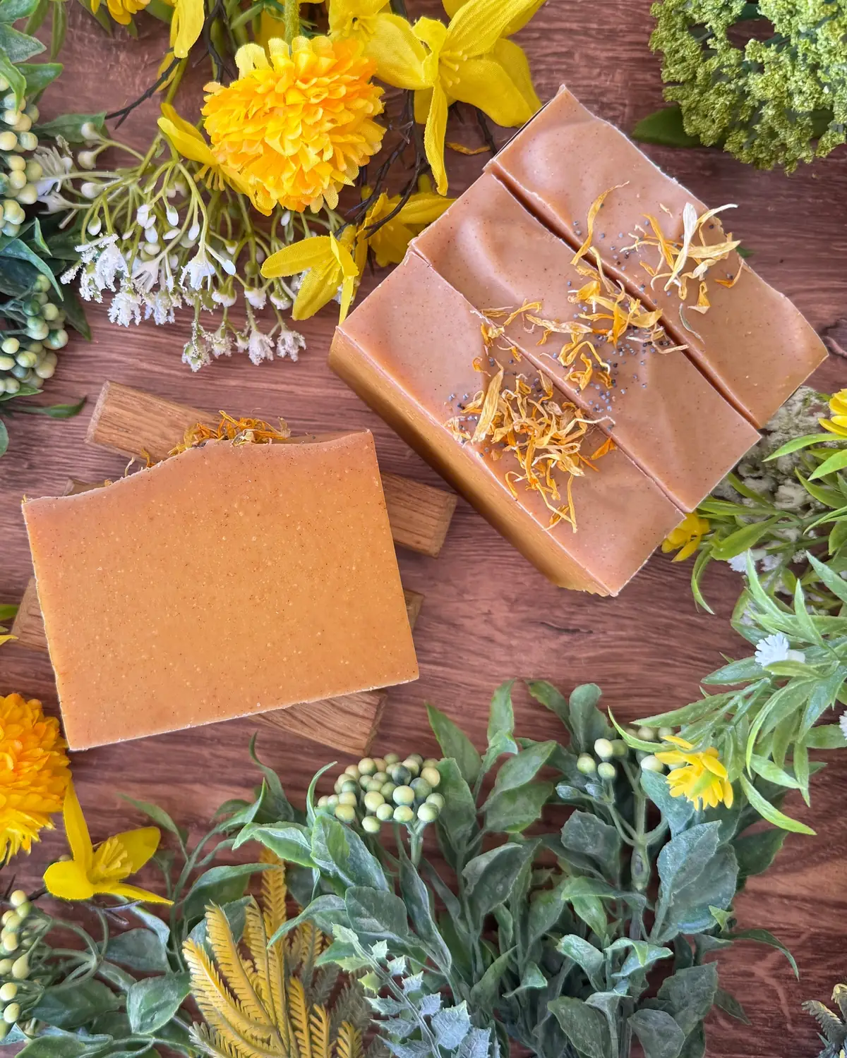 Tea Tree & Turmeric Soap photographed on wood with dried flowers